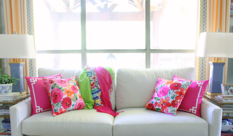 pink floral pillows on and solid pink pillows on white sofa