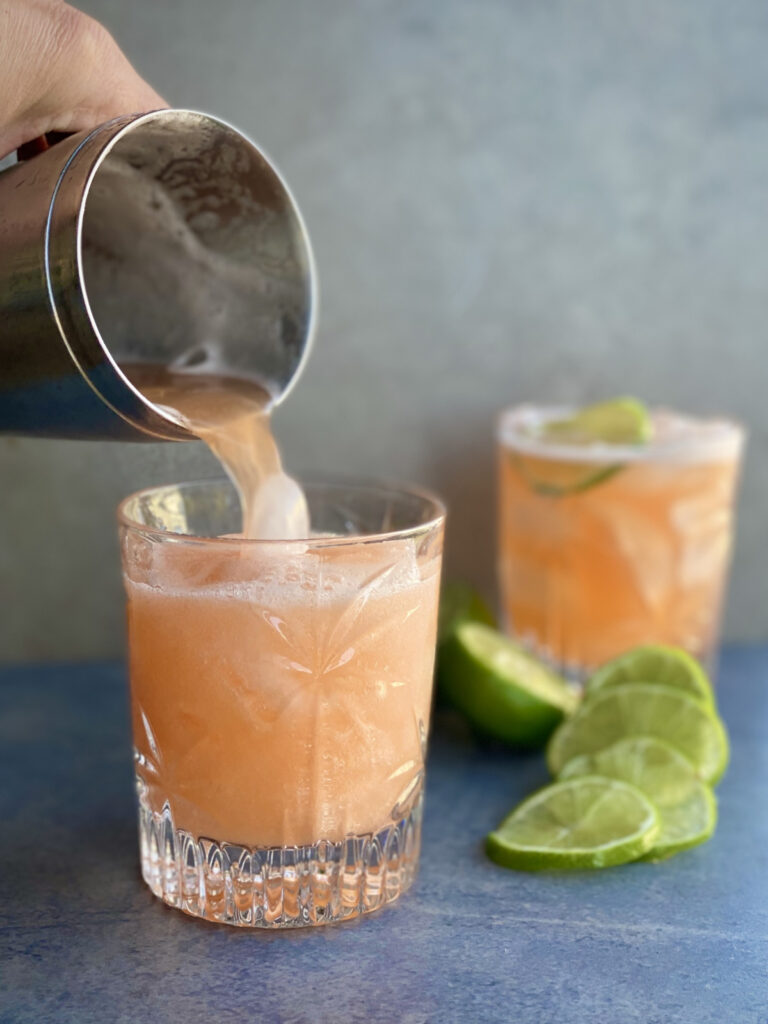 slushy pineapple cocktail with lime slice