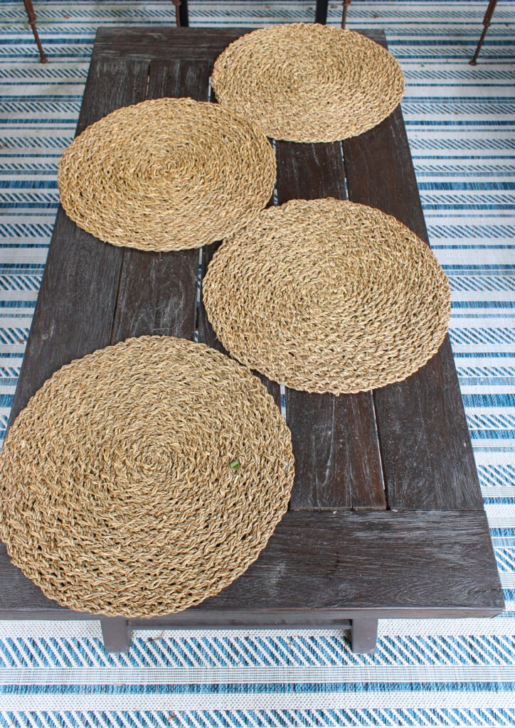 round woven placemats on wood patio table