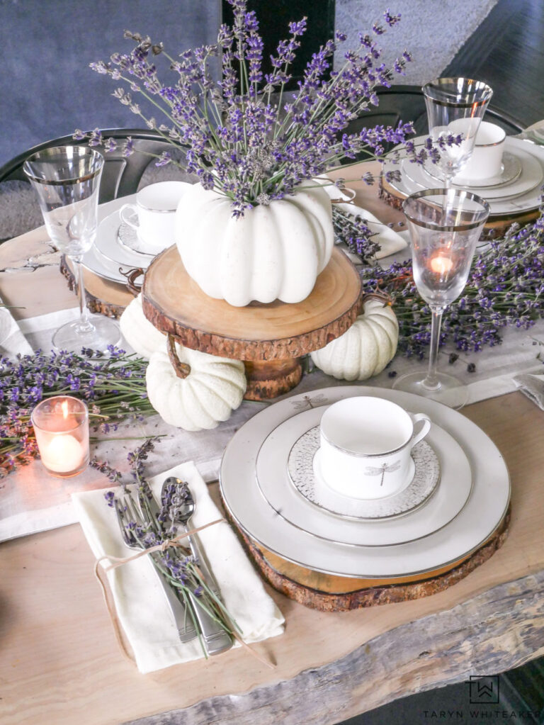 white plates and white pumpkins on fall table with lavender