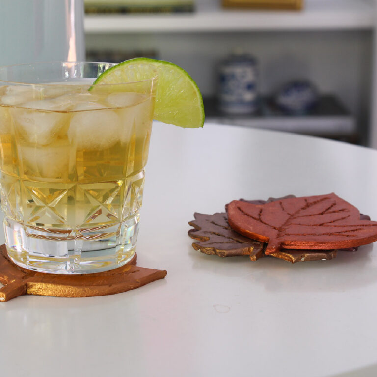 cocktail and stack of four air dry clay leaf coasters