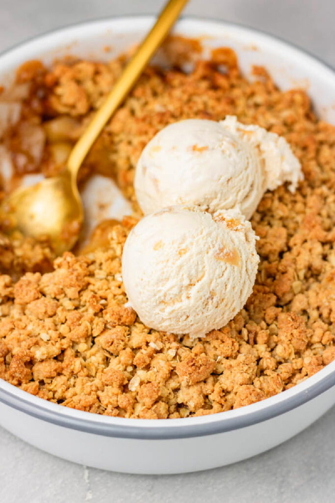 simple apple crumble with scoops of vanilla ice cream