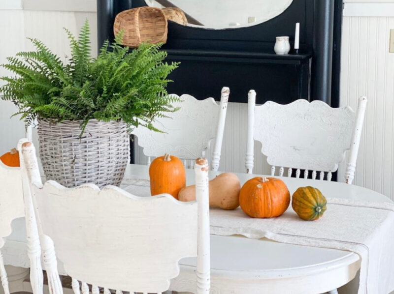white dining room table with orange pumpkins