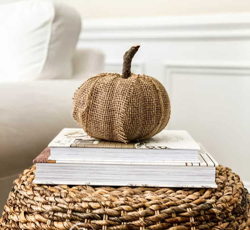 burlap pumpkin on a white book