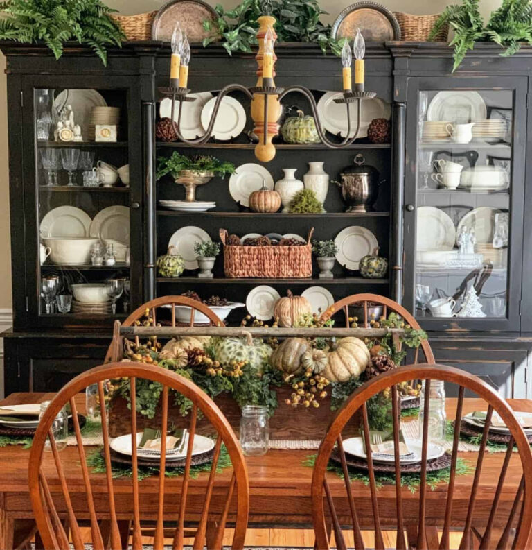 fall table with pumpkins and greenery on a wood box on a wood box