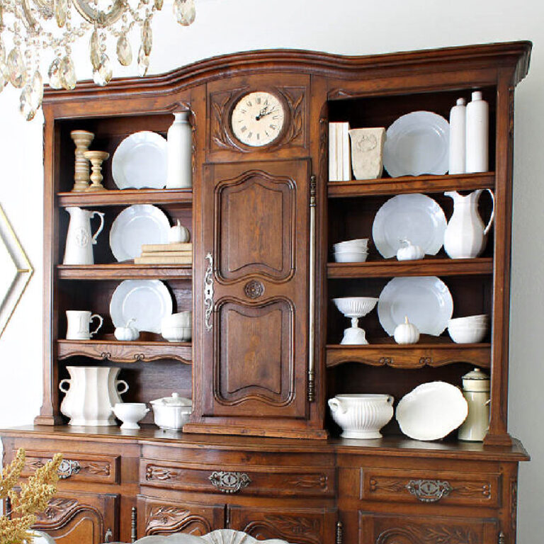 hutch decorated with white and neutral dishes and accessories