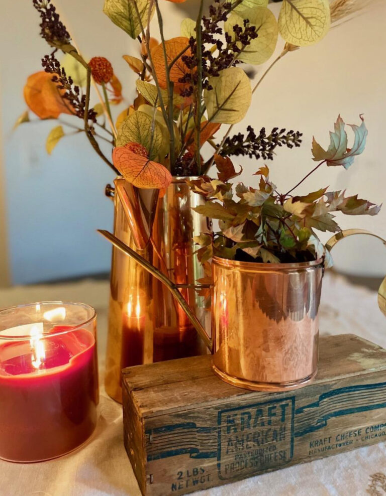 copper pitchers with fall stems and candle for budget-friendly fall decor