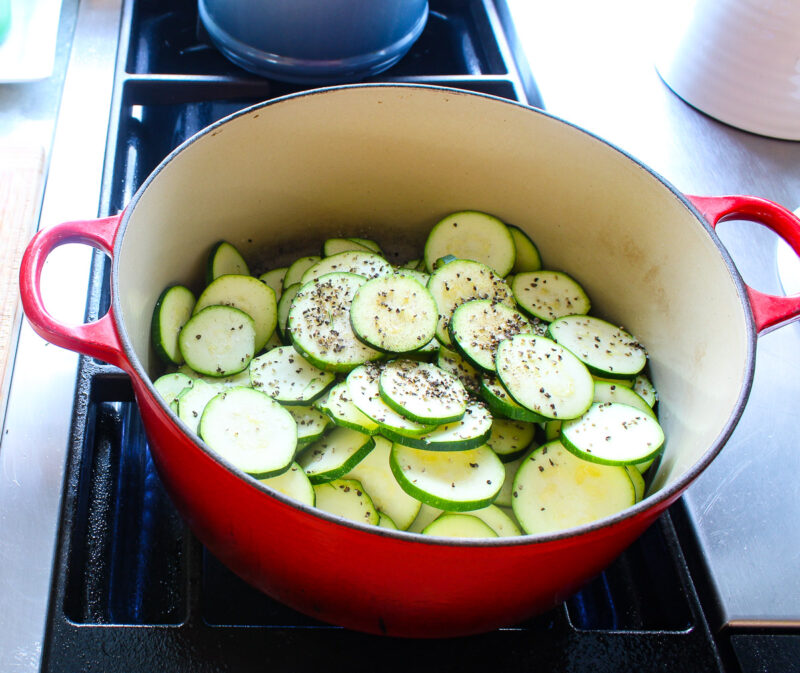 sliced zucchini in a Dutch oven on the stove top