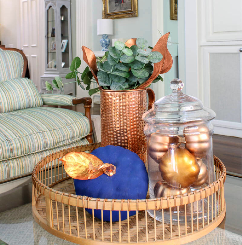 blue-painted pumpkin on coffee table