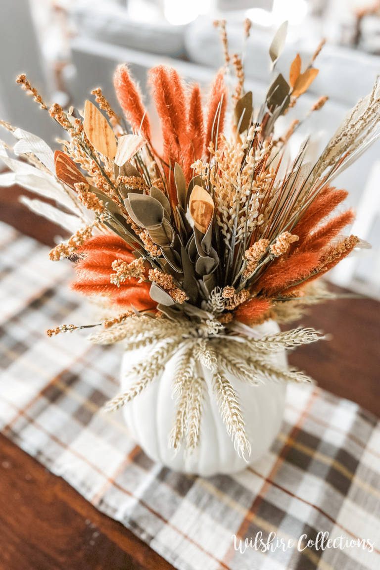 multi-colored fall stems in white pumpkins