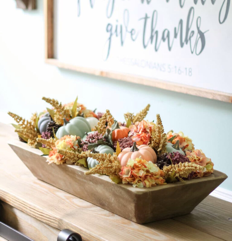 dough bowl filled with pumpkins and fall florals