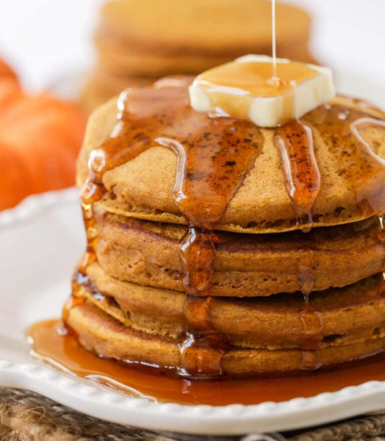 stack of pumpkin pancakes on a white plate