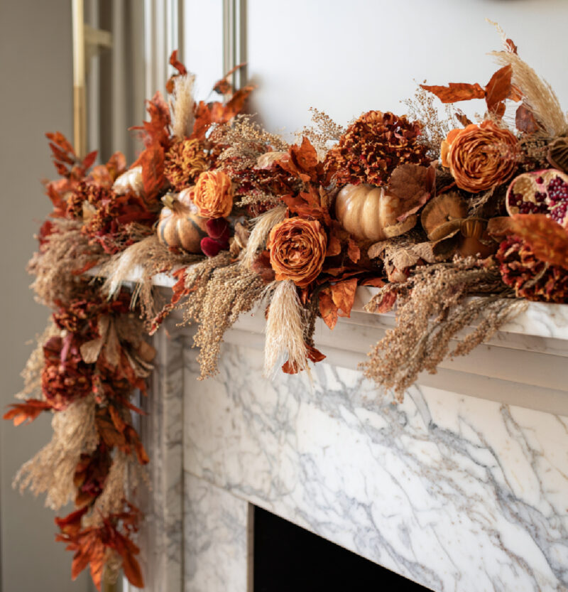 lush fall garland with wheat and pumpkins in deep orange