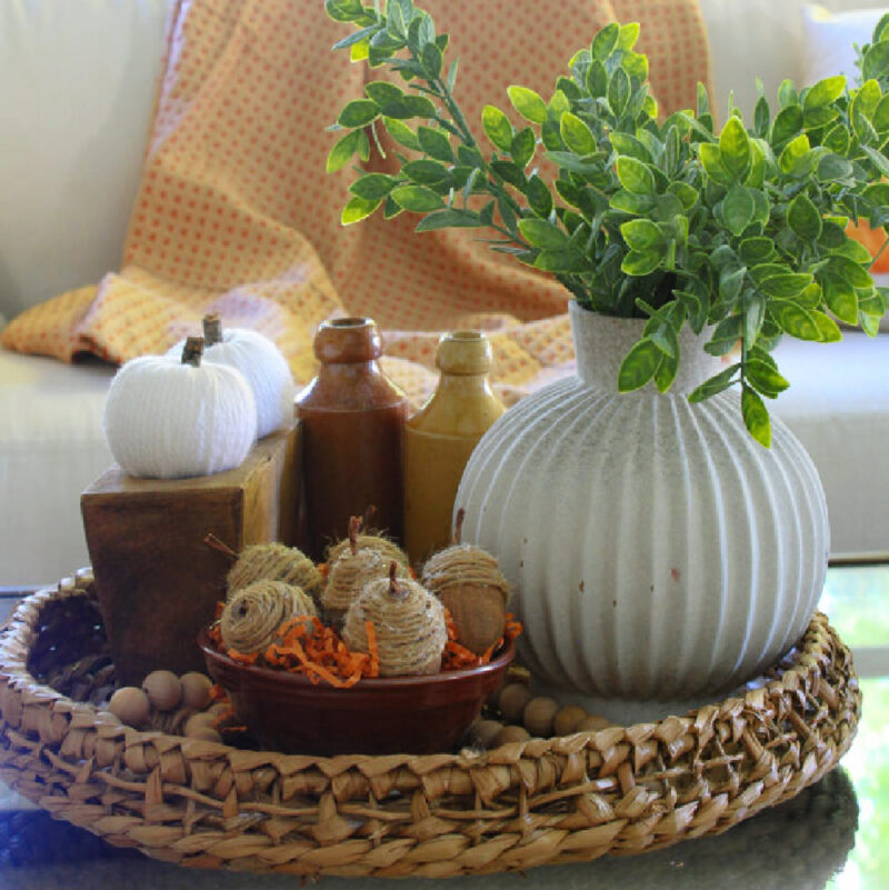 faux DIY acorns for fall decorating in basket on table