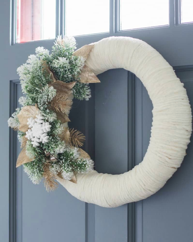 Christmas DIY yarn wreath on blue front door