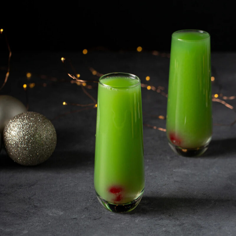a green drink in two tall glasses