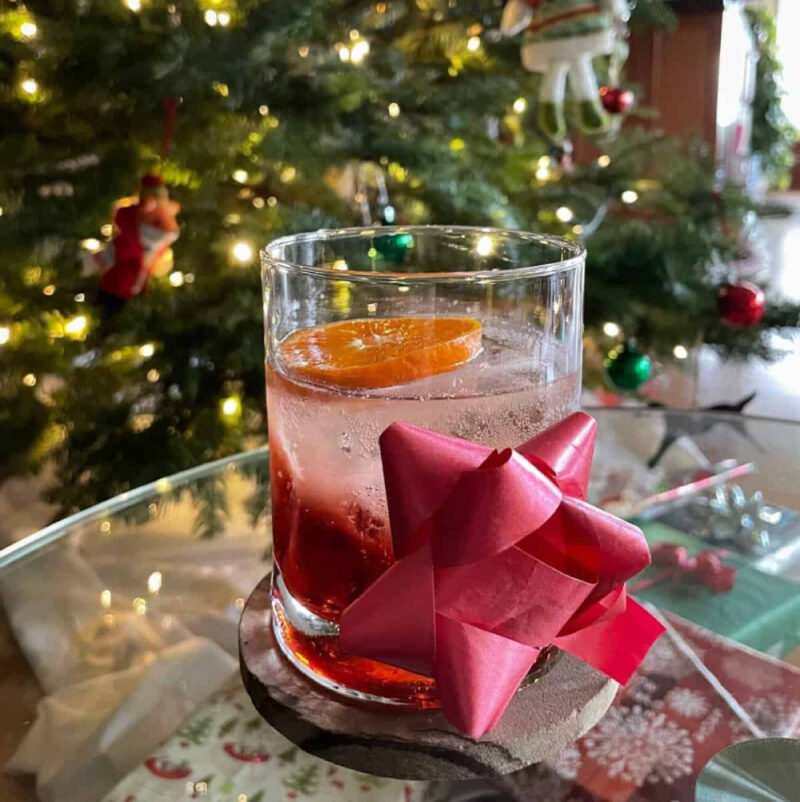 cocktail in a highball glass with a bow on the glass