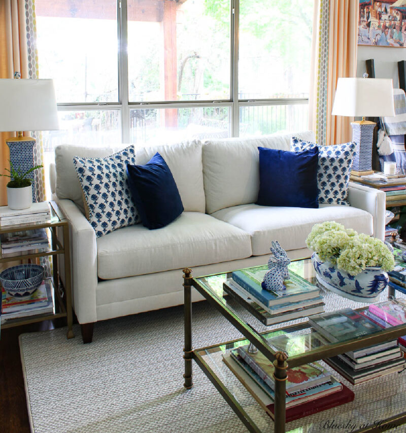 navy pillow and block pillow on white sofa