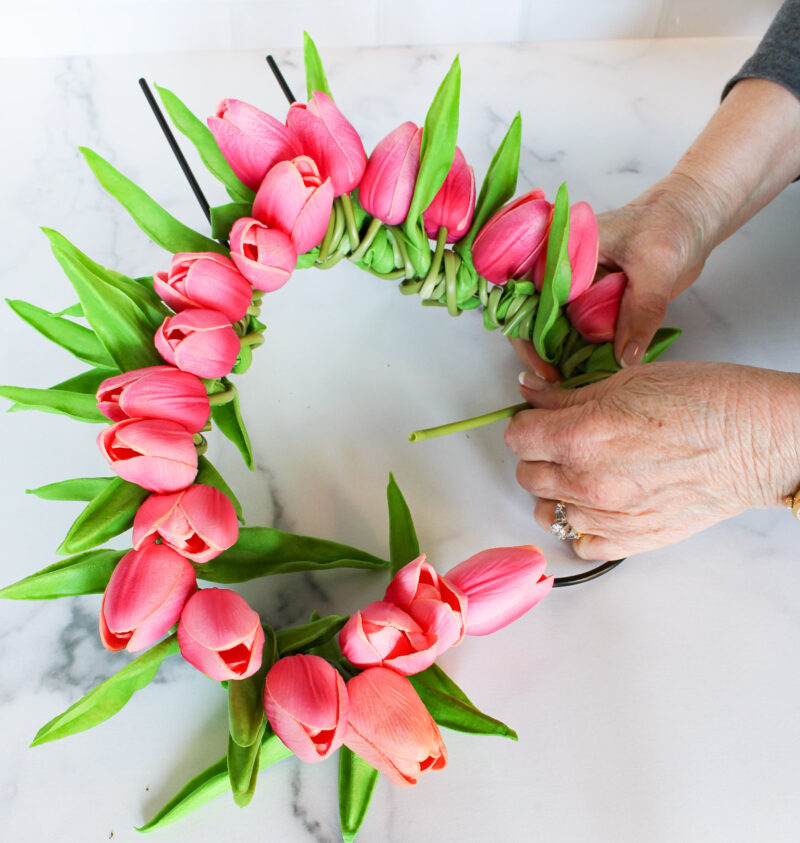 wrapping tulips and stems around wire form