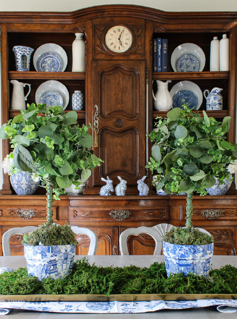 round topiaries in chinoiserie planters on dining room table