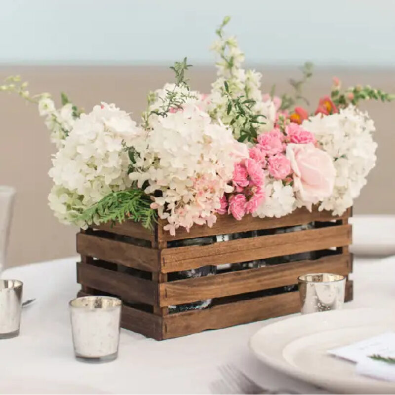 small brown DIY crate made with painter sticks and spring flowers