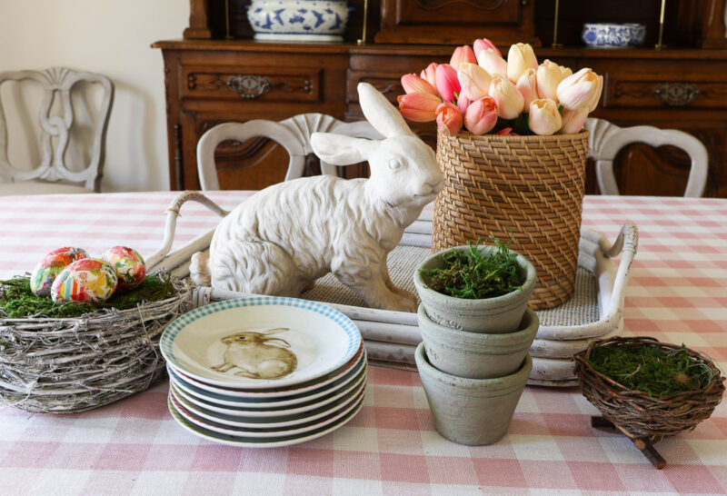 vintage green clay pots with cement bunny and tulips in basket with bunny plates