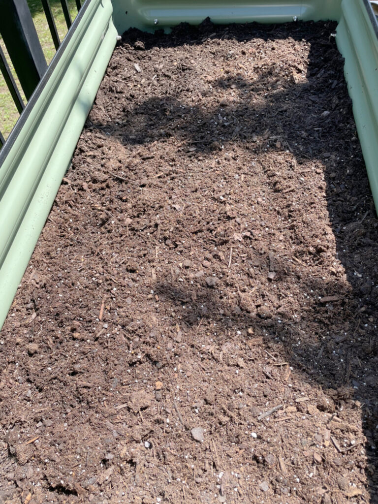 layer of compost in garden bed