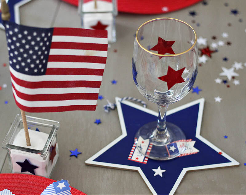 red vinyl decals on clear glass with blue wood star and American flag on table