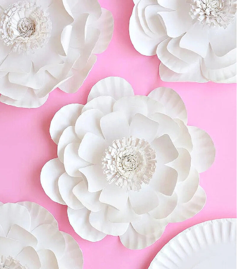 white paper plate flowers with embellishments