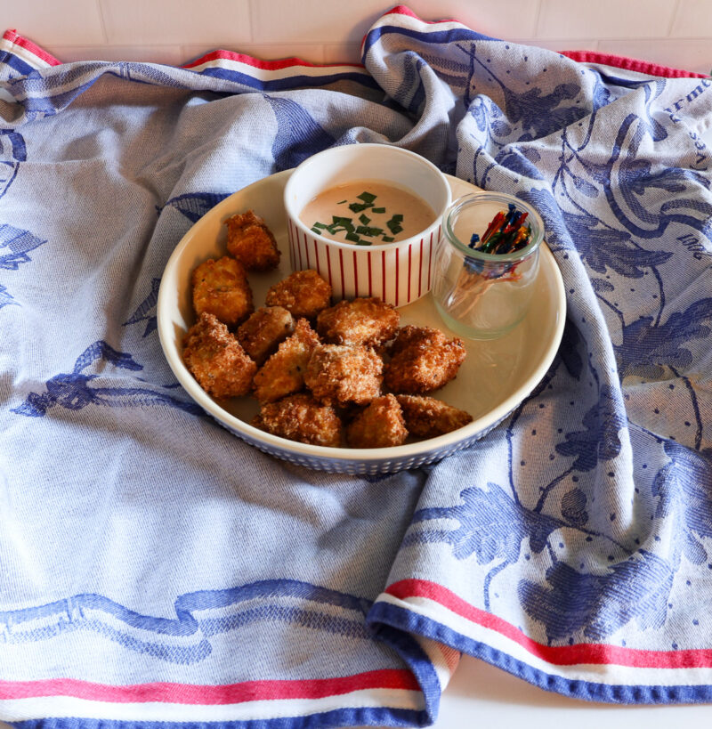 fried Banag Bang Chicken with sauce and toothpicks in a serving dish