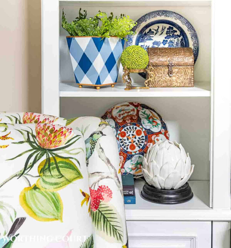 summer vignette with blue and white plaid container and floral fabric on chair