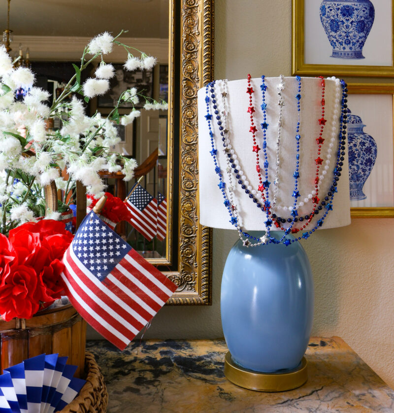 blue lamp with red, white, blue, and silver beads on it