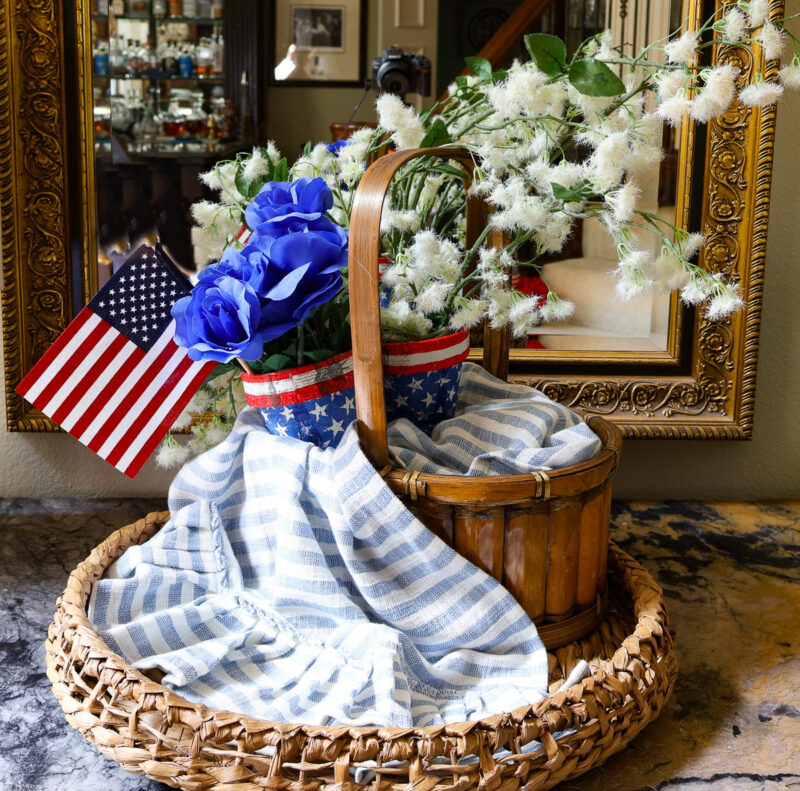 white and blue faux flowers in blue, white, and blue terra cotta pots
