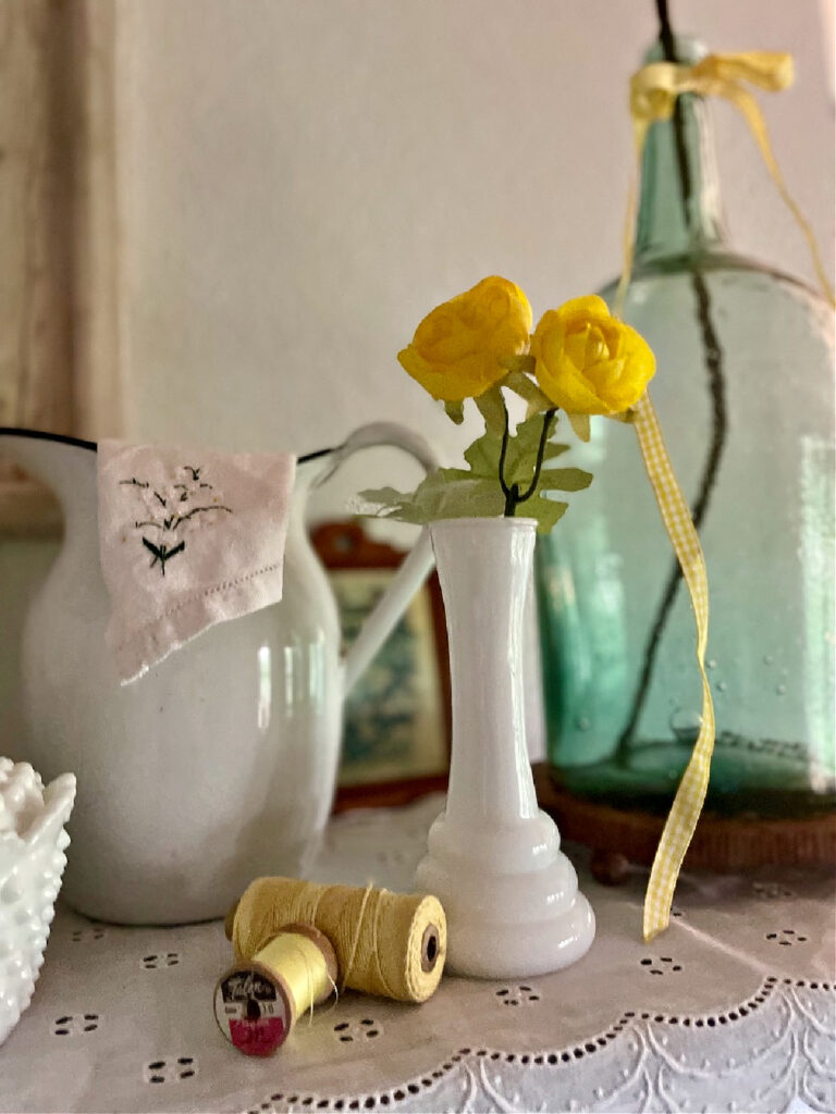 white milk glass vase with yellow flower
