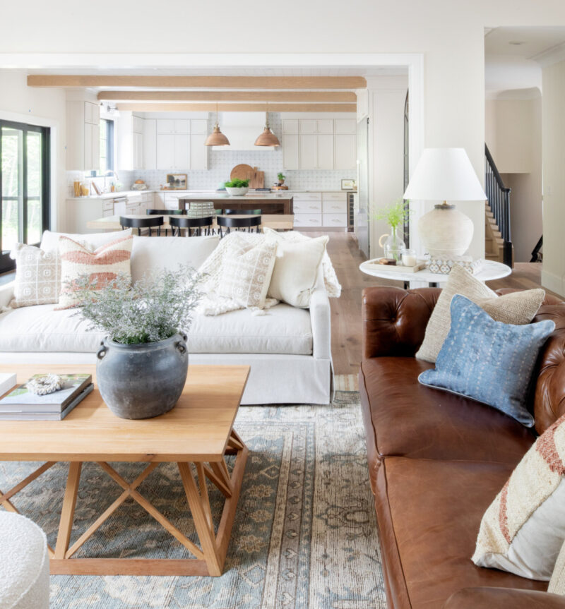 white living room with natural lighting, accent lamp and pendant lights