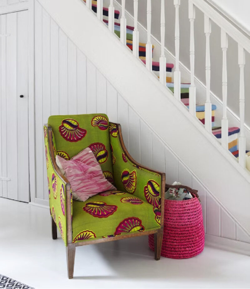 withe-painted staircase with colorful chair