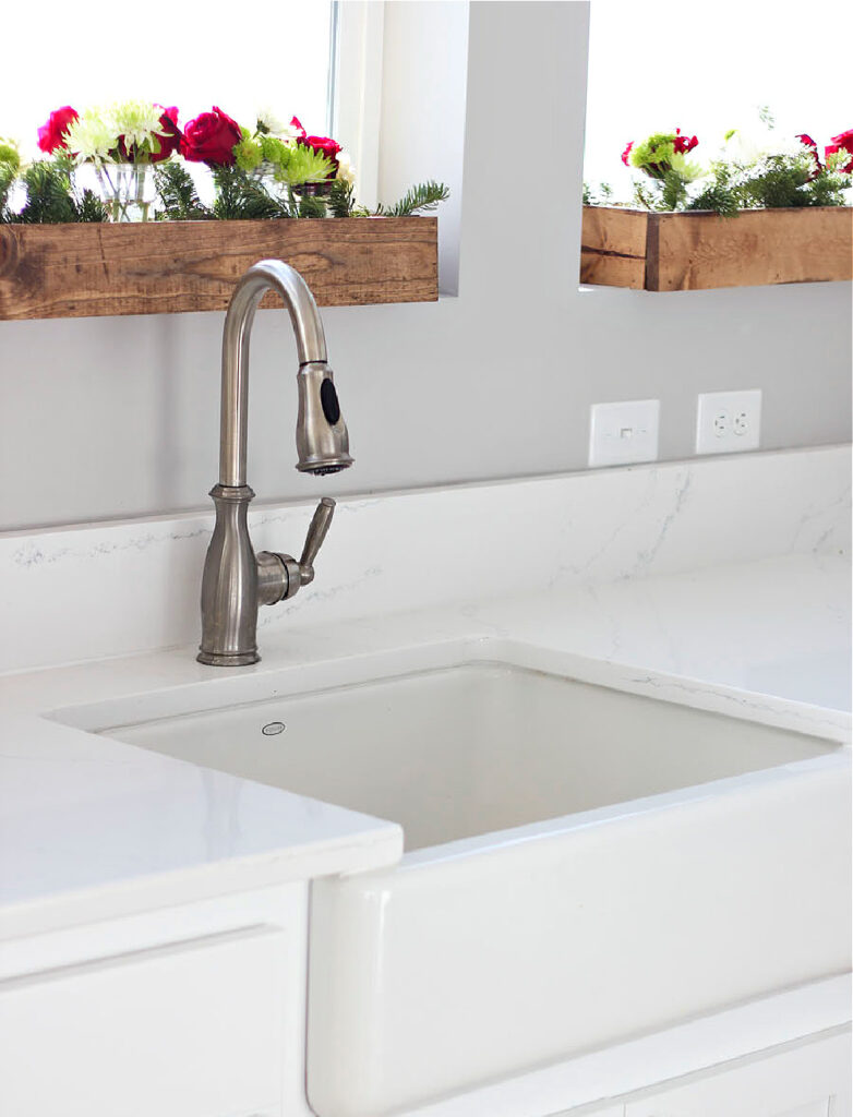 white sink and countertop with wood flower boxes