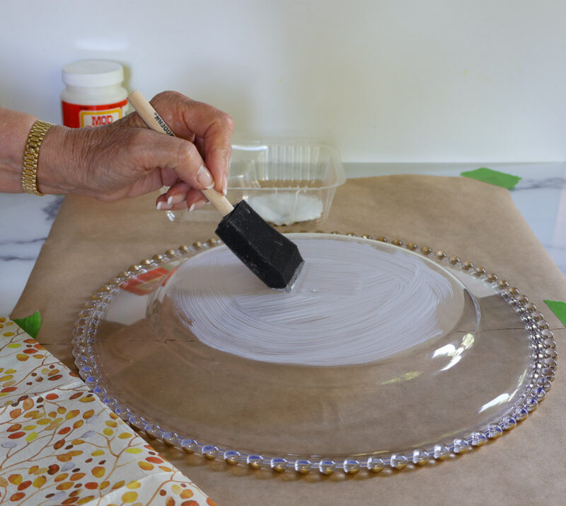 brushing ModPodge on back of clear plastic charger