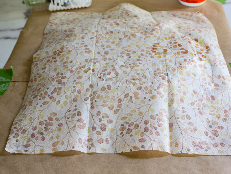 top layer of napkin on the back of charger