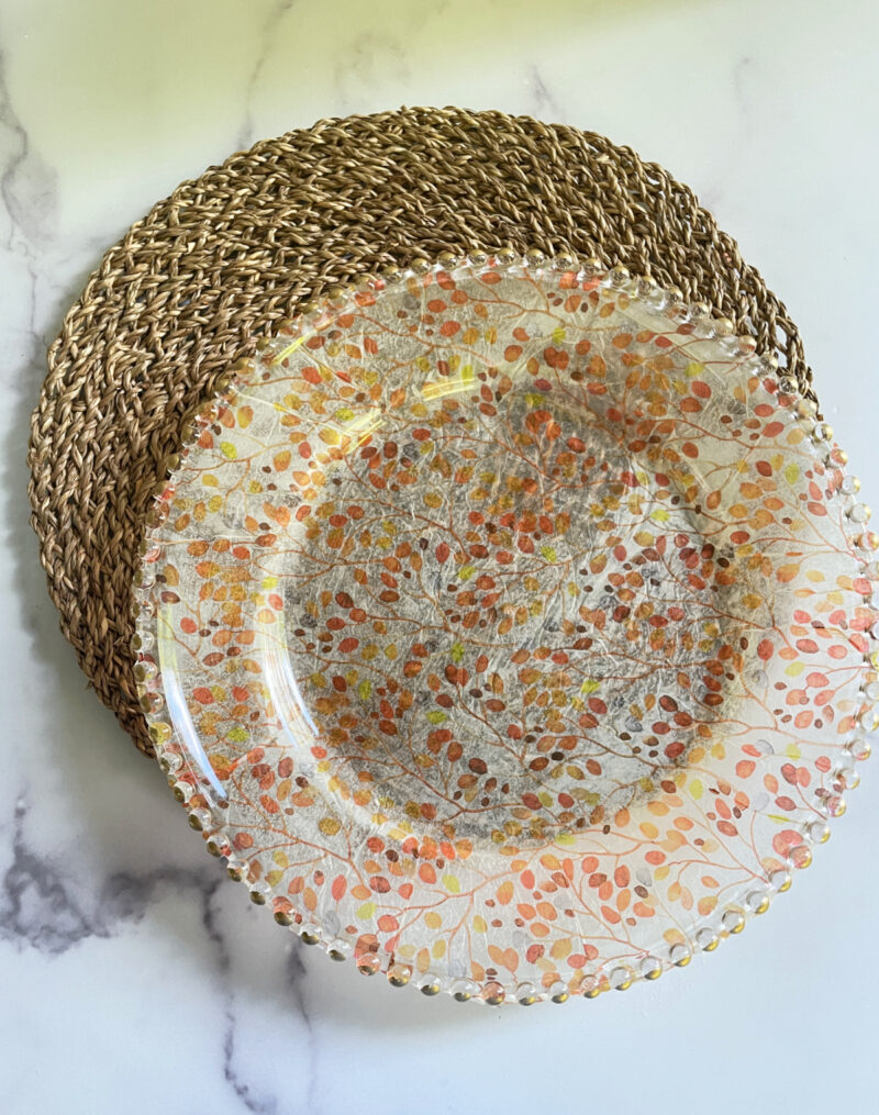 DIY fall decoupage charger with leaf design on top of a woven placemat