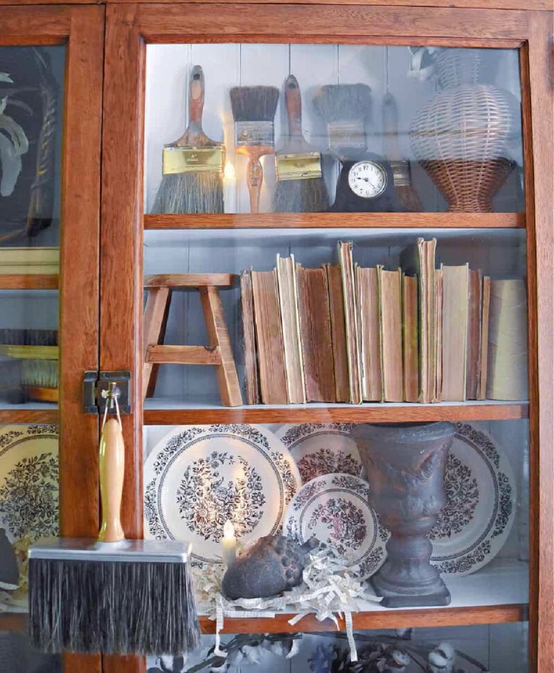 bookcase with glass doors decorated for fall