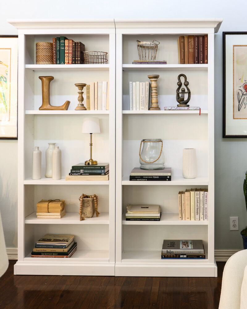 bookcase styled with natural and neutral accessories