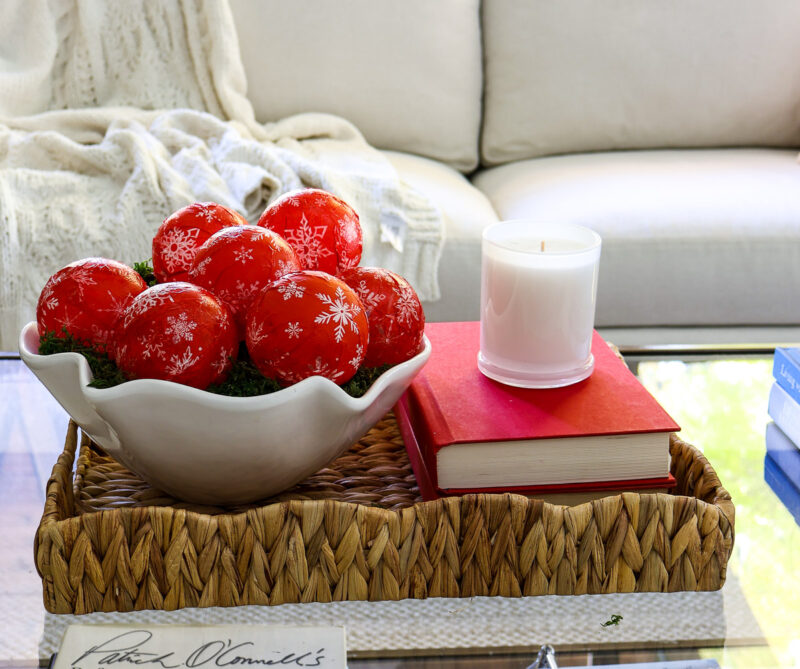 red books on tray with red ornaments