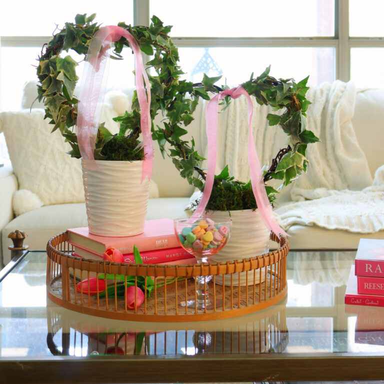 heart topiaries with pink ribbon on tray on coffee table