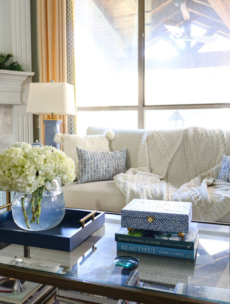 decorative blue box on coffee table with blue tray and white hydrangeas