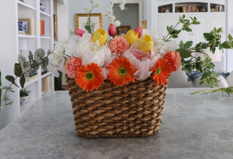orange zinnias in center front of arrangement