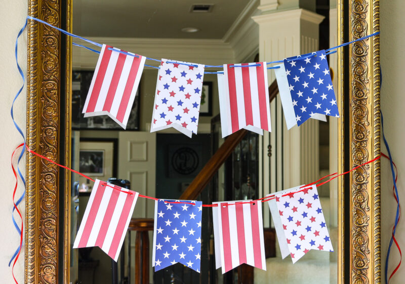 string of pennants on mirror in entry