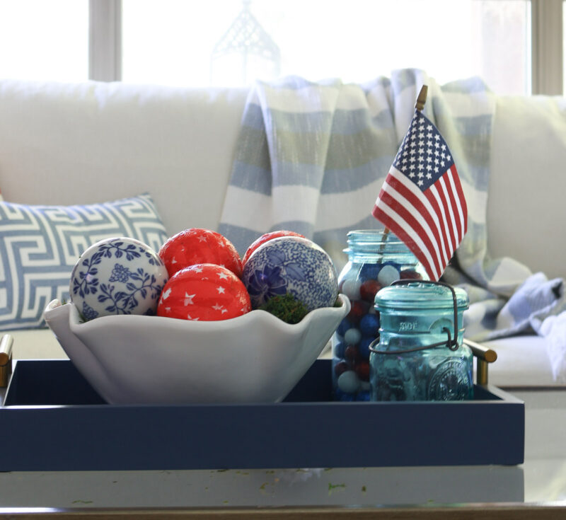 white bowl of red and blue balls in blue tray on coffee table
