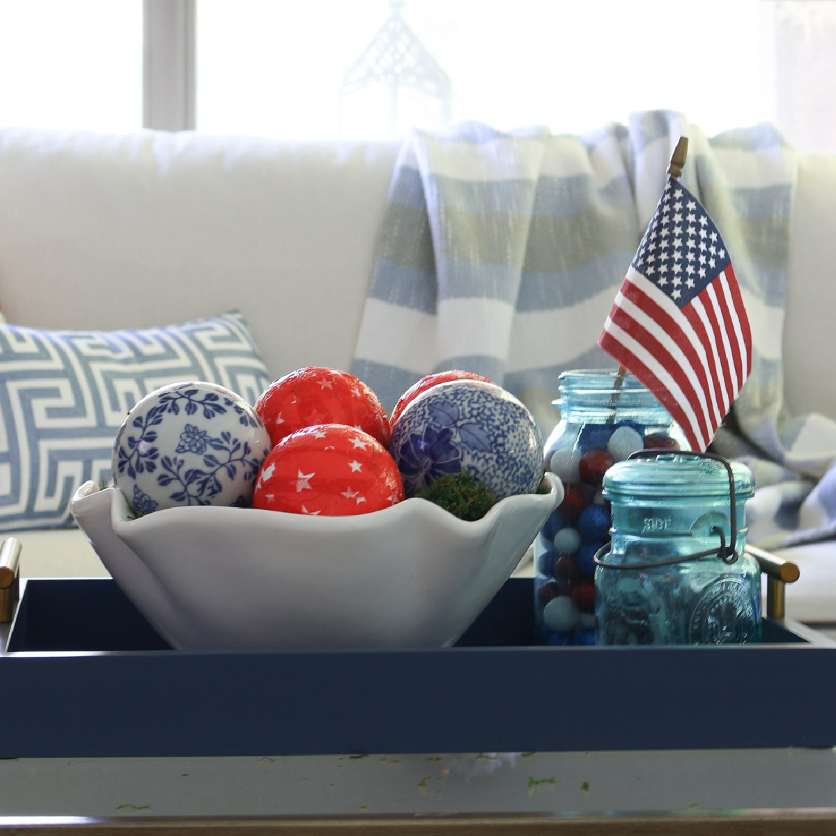white bowl of red and blue balls in blue tray on coffee table