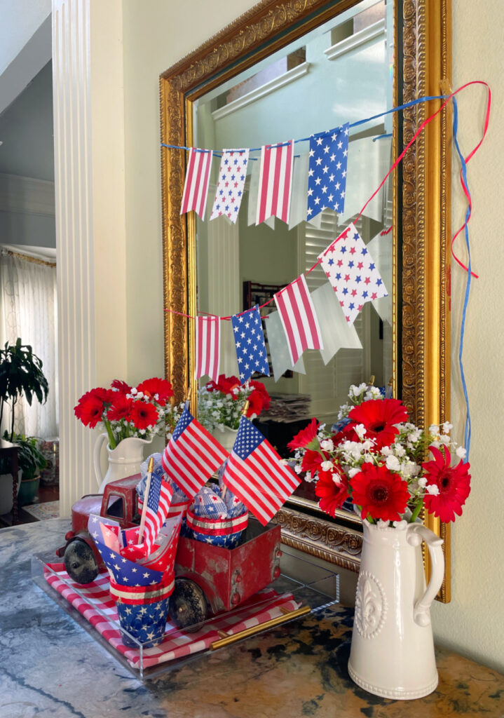 entry with red, white, and blue pennants, red truck and flags